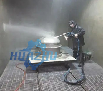 Manual cleaning of workpieces in sandblasting room